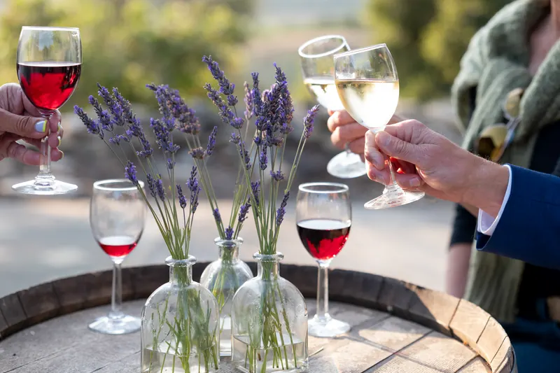 Guests raising glasses over a barrel with lavender